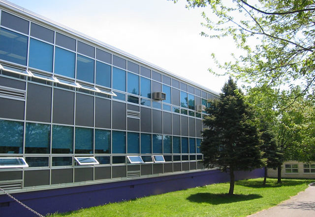 The image depicts a school with Mapes paneling.