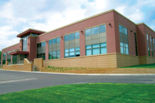 This image depicts a large law enforcement building with Mapes paneling.