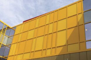 This image depicts a school building with yellow Mapes panels integrated into the design.