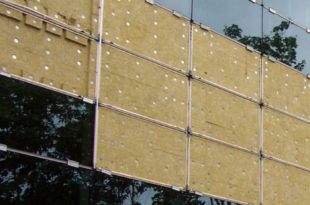Mapes factory-manufactured insulated back pans seen on the side of a building.
