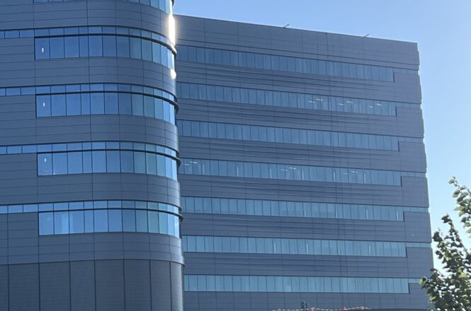 Close-up of the panel façade and ribbon windows on the Atrium Health Bed Tower